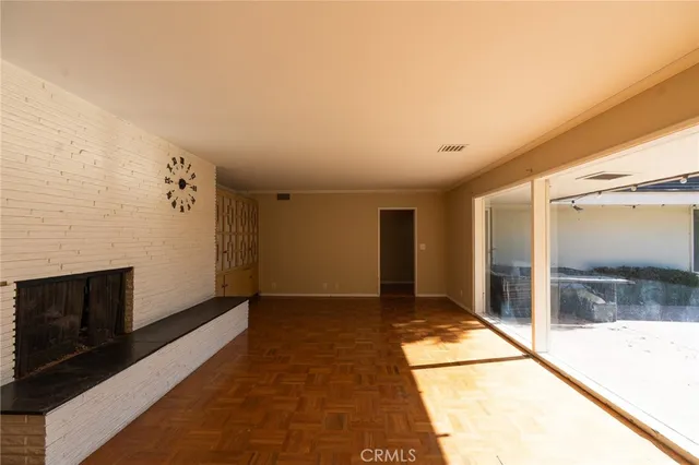 a view of a hallway with wooden floor and a fireplace