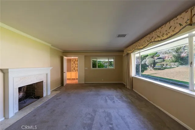 a view of empty room with a fireplace