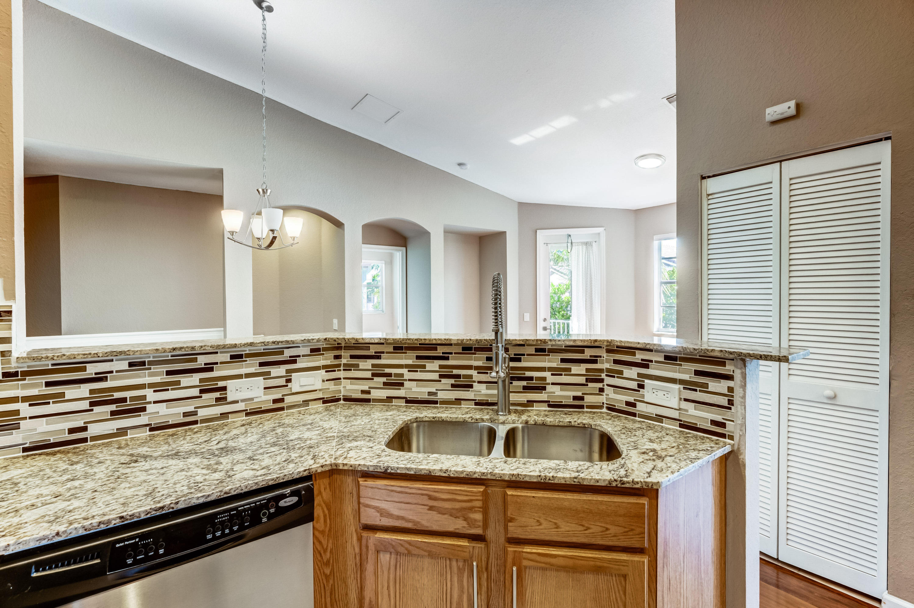 3174 Laurel Ridge Circle Riviera Beach, FL 33404 - Photo 2 of 32 a bathroom with a sink stove and mirror