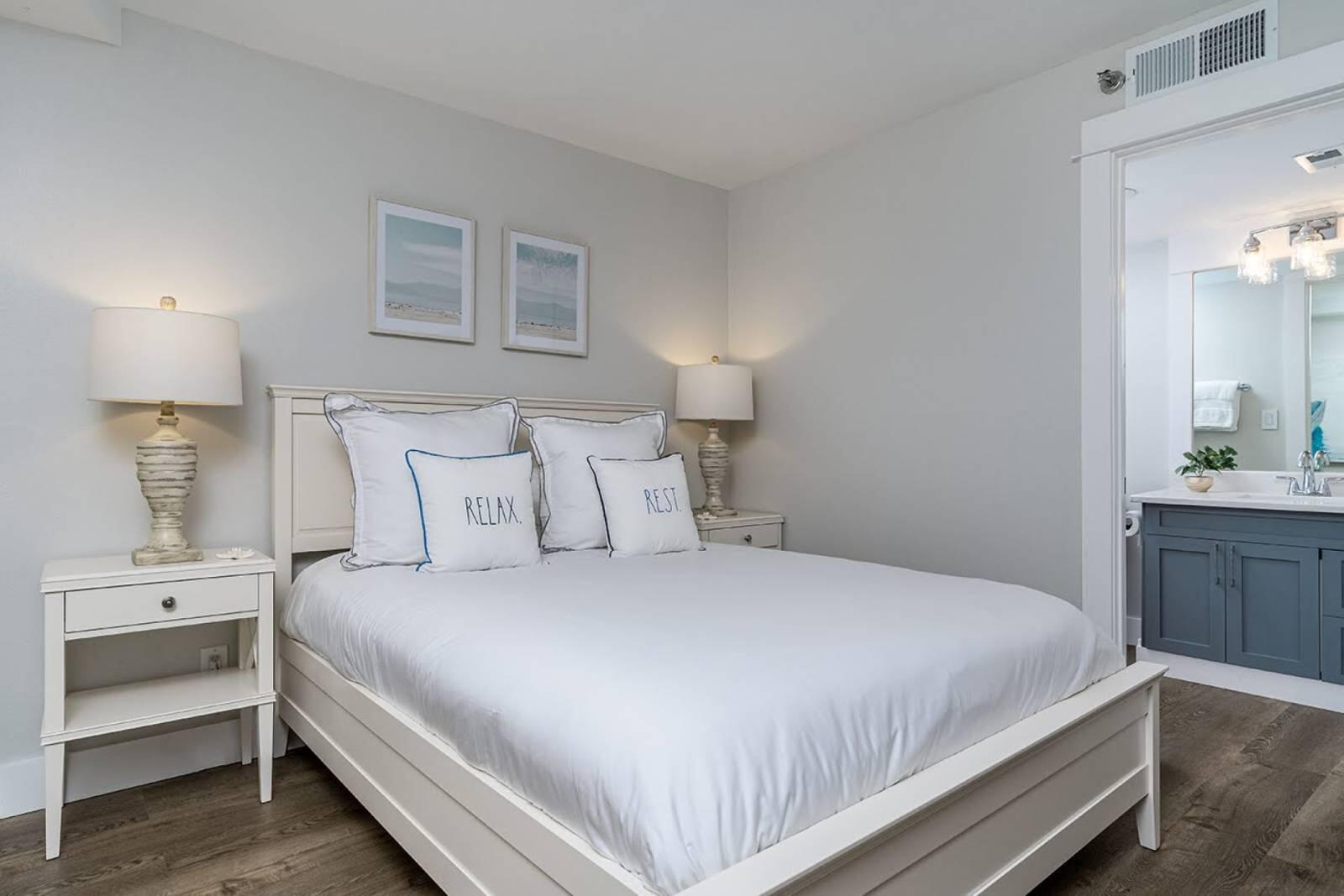 4017 Beachside 1, Unit 4017 Miramar Beach, FL 32550 - Photo 16 of 26 a bedroom with a bed and a lamp on dresser