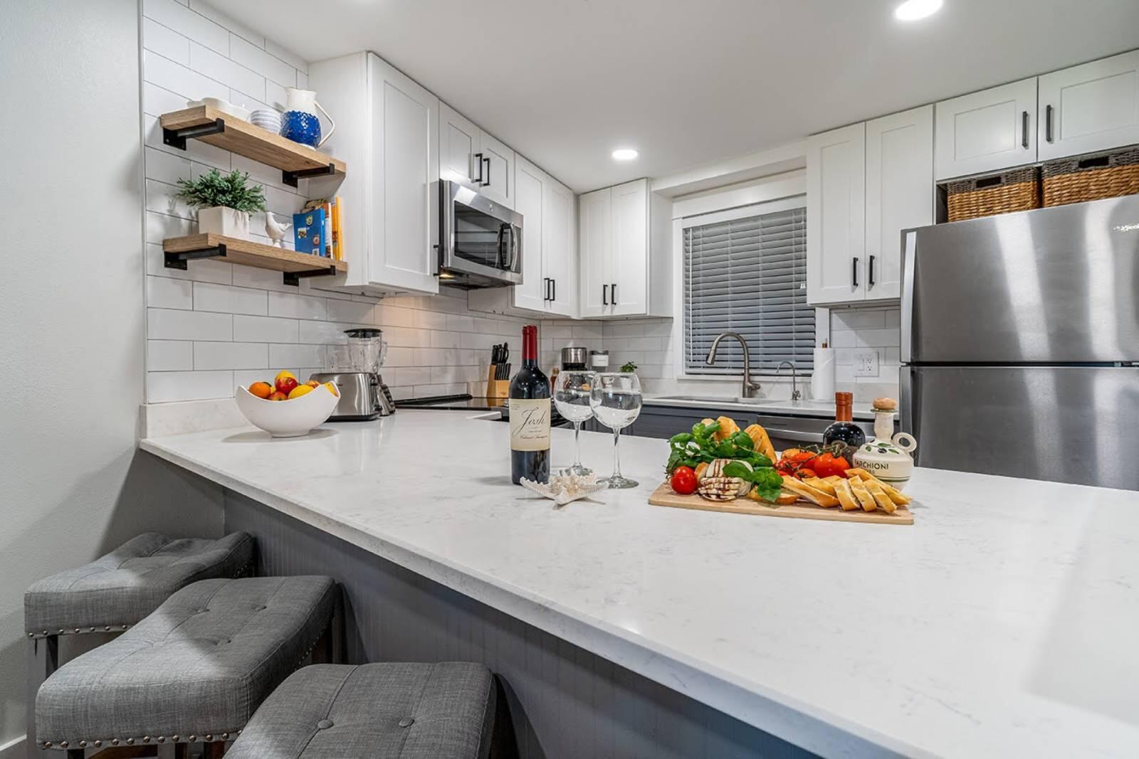4017 Beachside 1, Unit 4017 Miramar Beach, FL 32550 - Photo 8 of 26 a kitchen with stainless steel appliances a sink a refrigerator a microwave a stove and a refrigerator