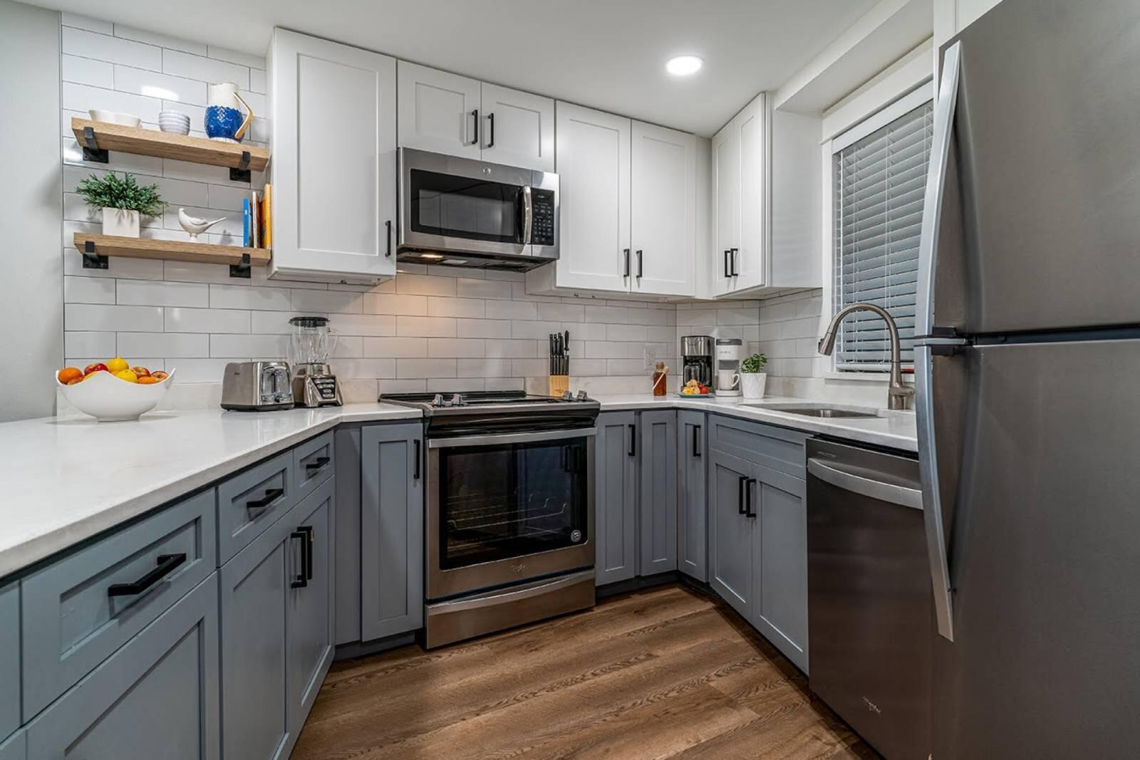 4017 Beachside 1, Unit 4017 Miramar Beach, FL 32550 - Photo 9 of 26 a kitchen with stainless steel appliances granite countertop a refrigerator sink and stove