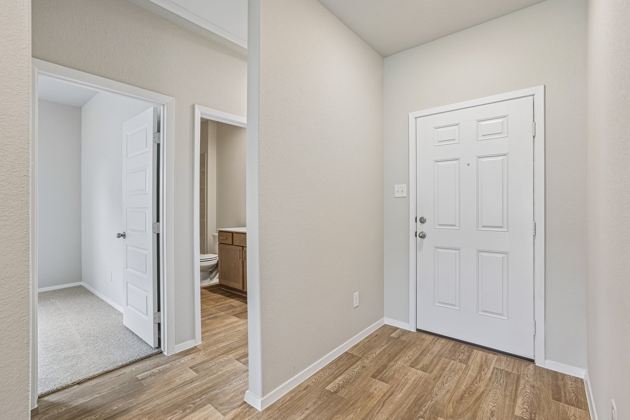 5513 Sacra Cove Austin, TX 78747 - Photo 6 of 37 a view of an empty room and wooden floor