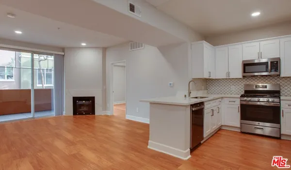 a kitchen with granite countertop a stove top oven and sink