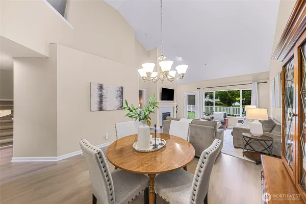 a view of a dining room with furniture a chandelier and wooden floor