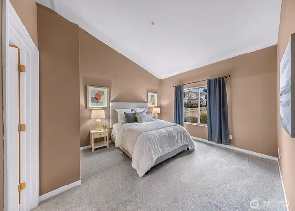 a bedroom with a bed and a large window