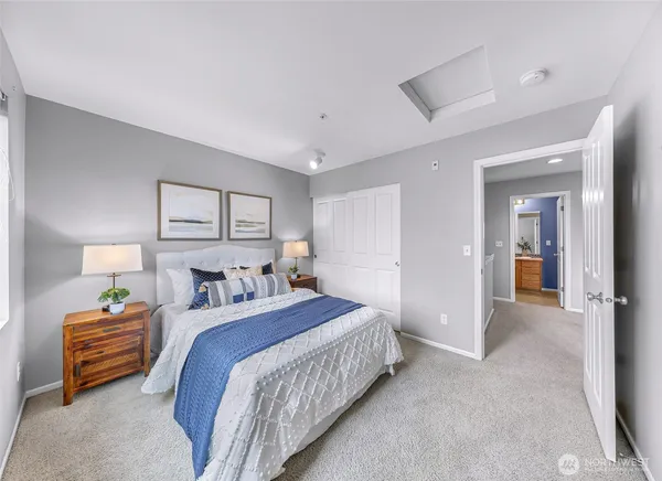 a bedroom with a bed and a lamp