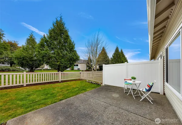 a view of a patio with a table and chairs