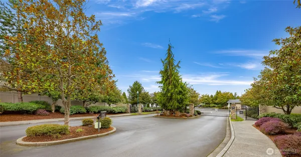 a view of a house with backyard and trees
