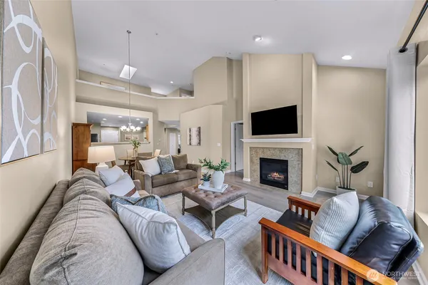 a living room with furniture a fireplace and a flat screen tv