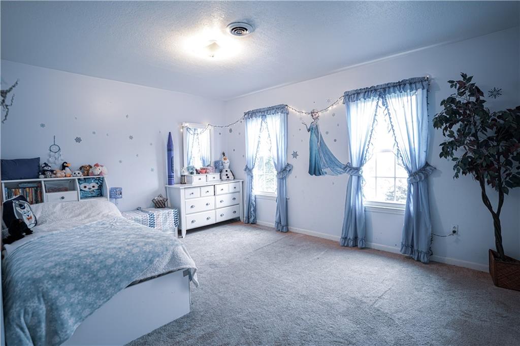 105 Tate Road Hookstown, PA 15050 - Photo 13 of 25 a bedroom with a bed and a potted plant