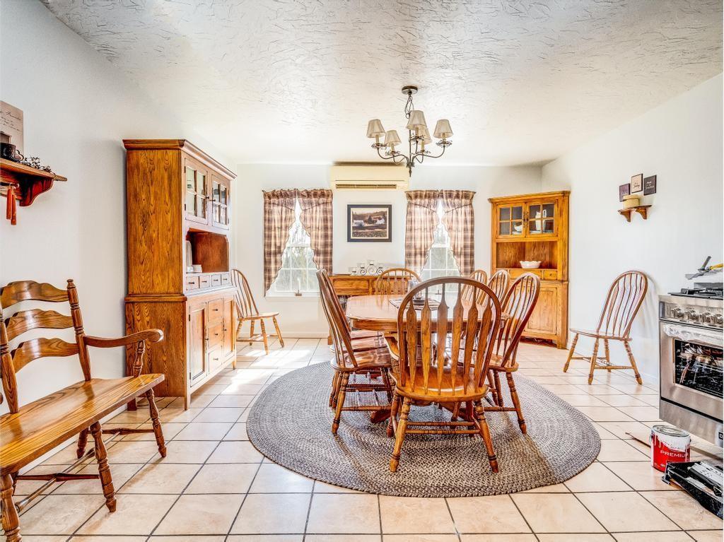 105 Tate Road Hookstown, PA 15050 - Photo 7 of 25 a dining room with furniture a rug and a chandelier