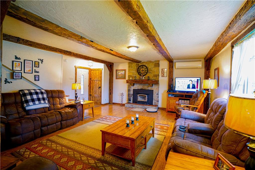 105 Tate Road Hookstown, PA 15050 - Photo 8 of 25 a living room with furniture a fireplace and a large window