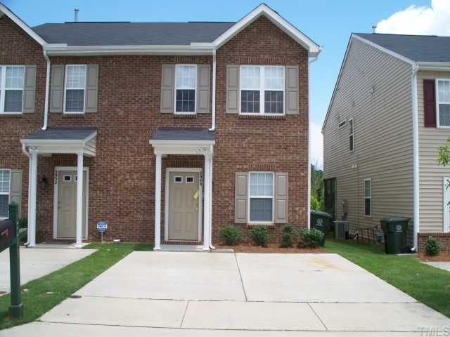 5948 Osprey Cove Drive Raleigh, NC 27604 - Photo 1 of 12 a front view of a house with a yard and a garage