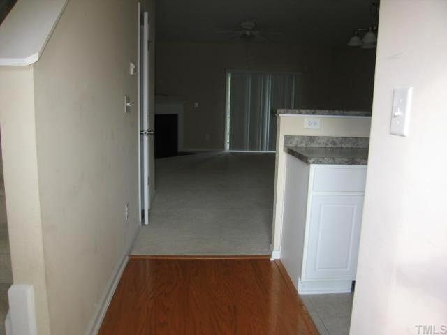 5948 Osprey Cove Drive Raleigh, NC 27604 - Photo 2 of 12 an empty room with wooden floor and entrance
