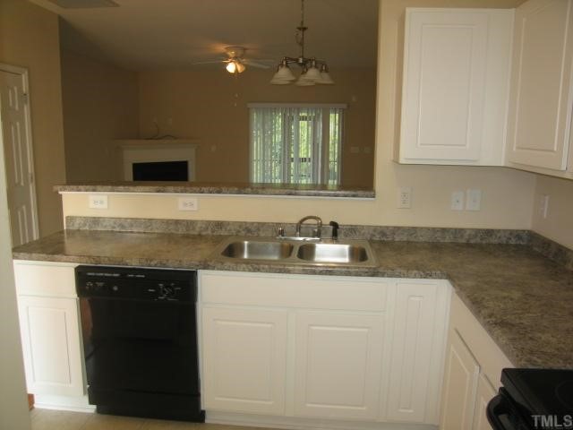 5948 Osprey Cove Drive Raleigh, NC 27604 - Photo 5 of 12 a kitchen with granite countertop white cabinets and a sink