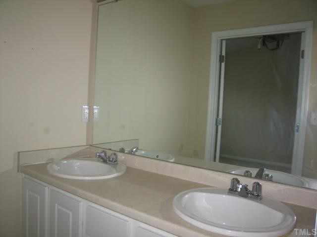 5948 Osprey Cove Drive Raleigh, NC 27604 - Photo 7 of 12 a bathroom with a sink and a mirror