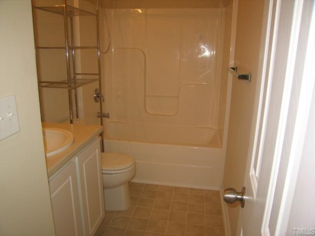 5948 Osprey Cove Drive Raleigh, NC 27604 - Photo 10 of 12 a bathroom with a granite countertop toilet and a shower