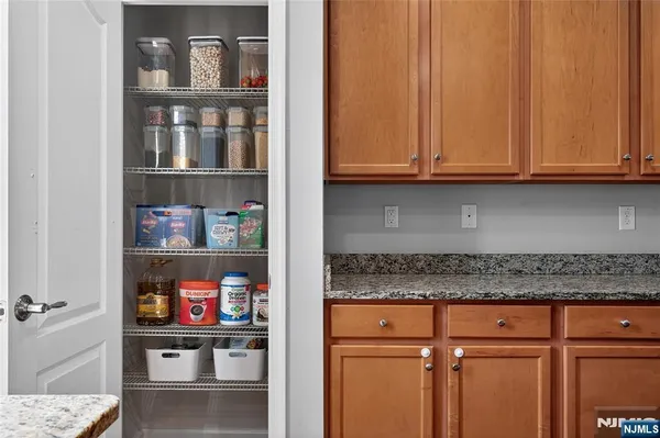 a kitchen with granite countertop cabinets and a wooden floor
