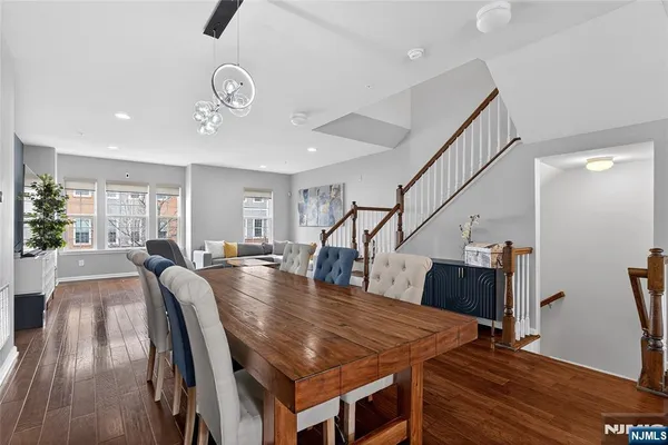 a dining room with furniture and wooden floor