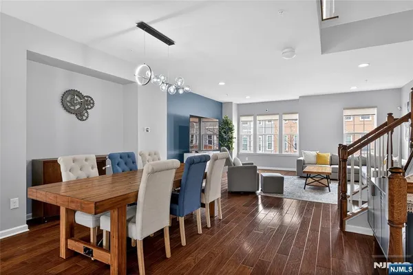 a dining room with wooden floor a glass table and chairs