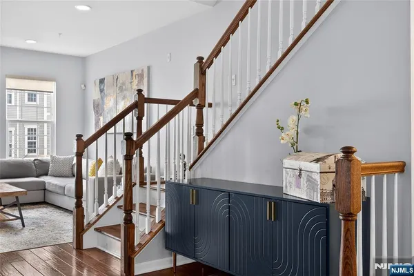 a view of entryway livingroom and hall with wooden floor