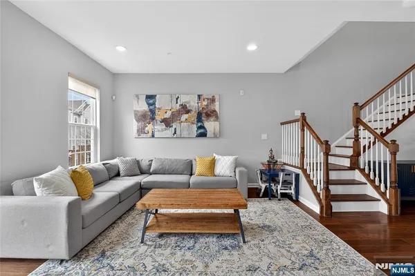 a living room with furniture a rug and a window