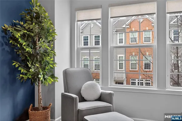 a living room filled with furniture and a potted plant
