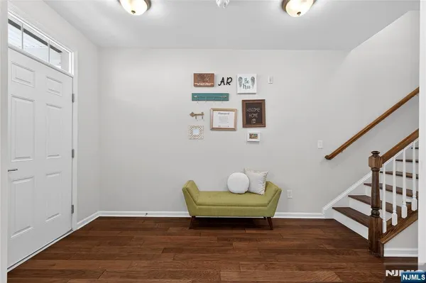 a view of room with stairs and wooden floor
