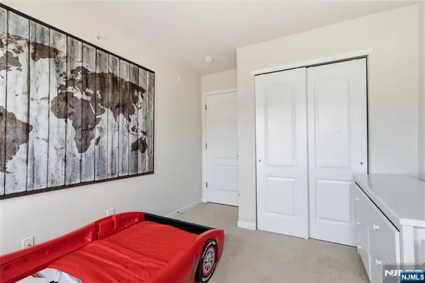 a bedroom with a bed and a mirror
