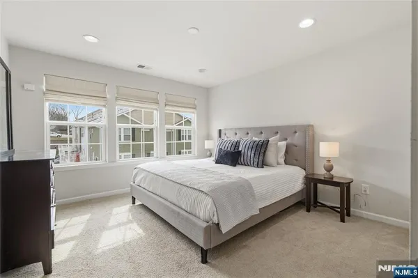 a bedroom with a large bed and a walk in closet