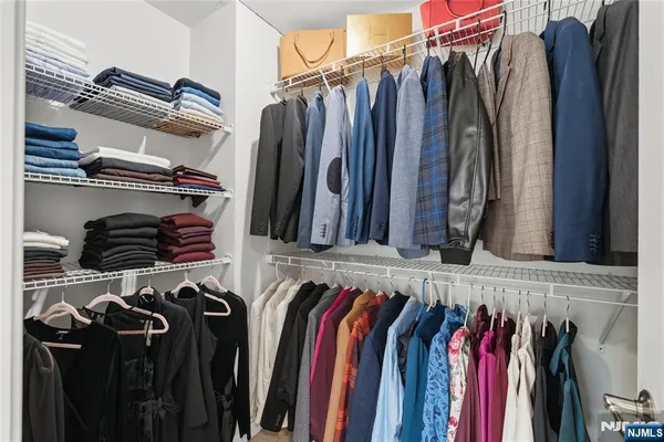 a bathroom with a granite countertop bathtub a double vanity sink a vanity and a large mirror