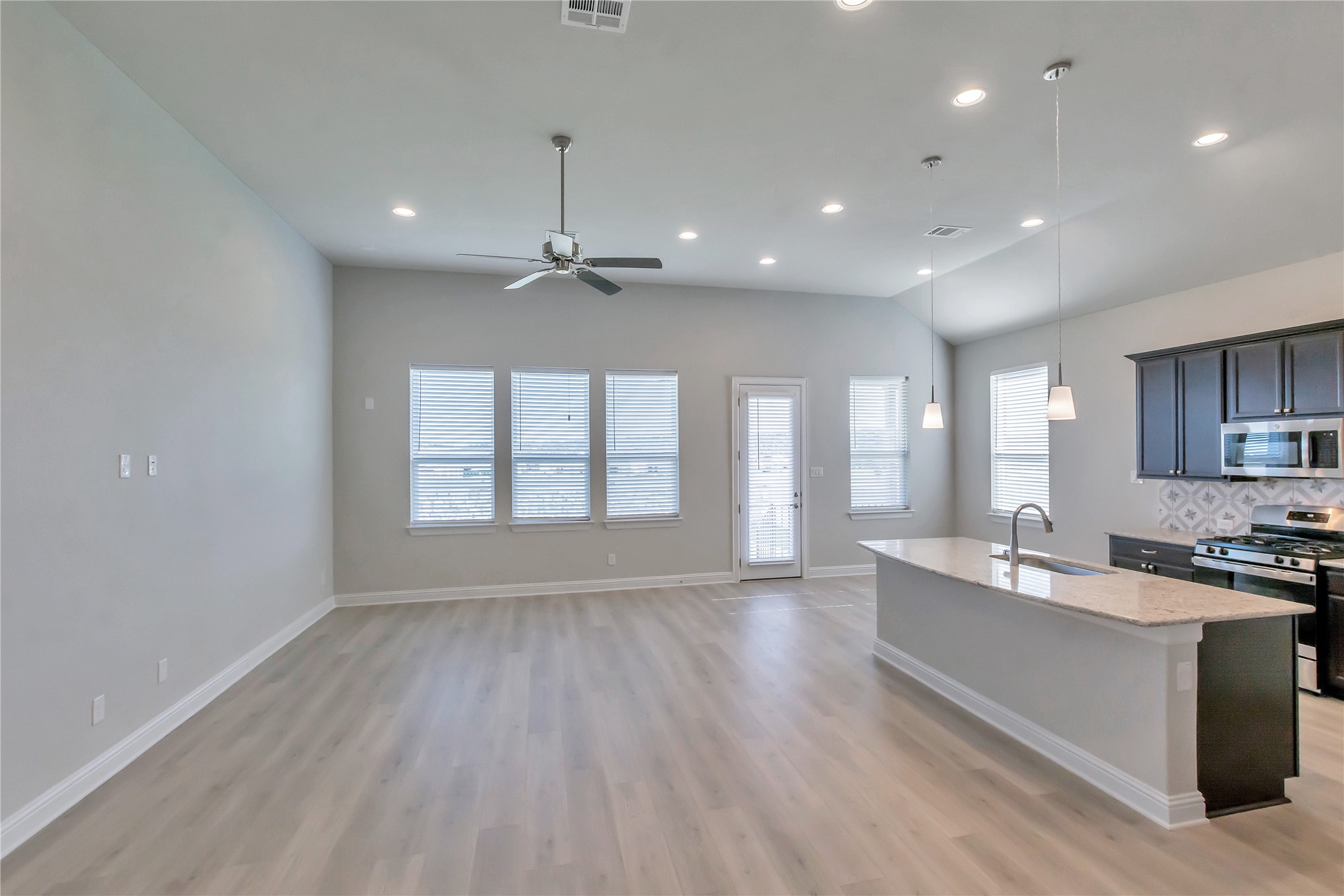 2140 Base Burner Path Leander, TX 78641 - Photo 5 of 27 a large kitchen with stainless steel appliances a large counter top a sink a refrigerator and a window