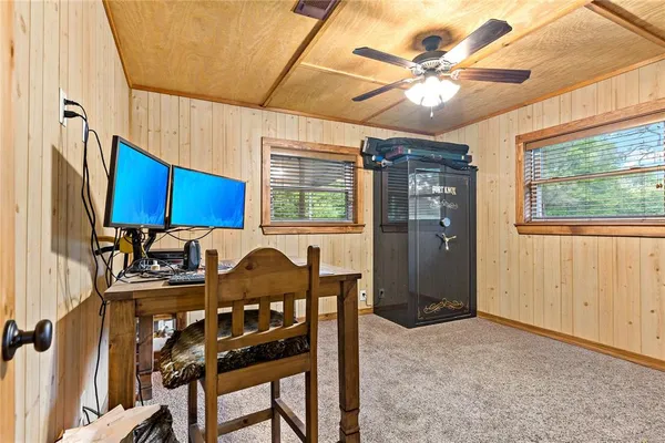 a view of a workspace with furniture and a window