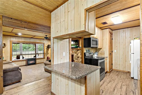 a kitchen with stainless steel appliances granite countertop a sink and cabinets