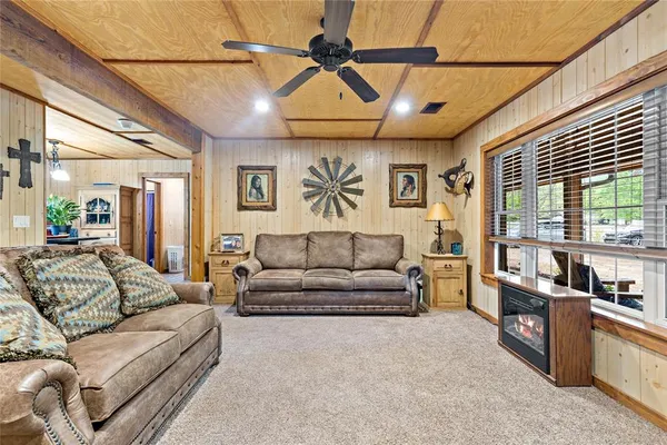 a living room with furniture and a ceiling fan