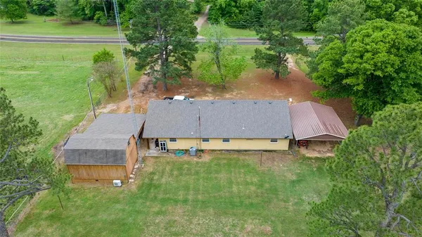 a aerial view of a house with a yard and lake view