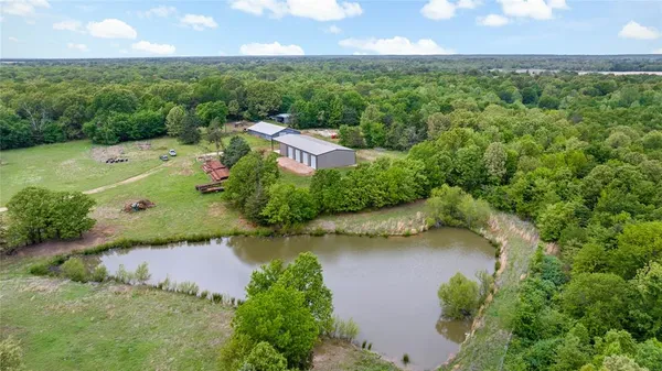 an aerial view of residential houses with outdoor space and lake view