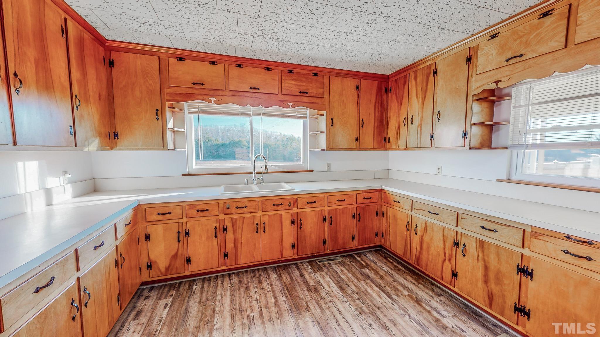 3772 Mt Harmony Church Road Rougemont, NC 27572 - Photo 13 of 66 a kitchen with granite countertop wooden cabinets a sink and a window