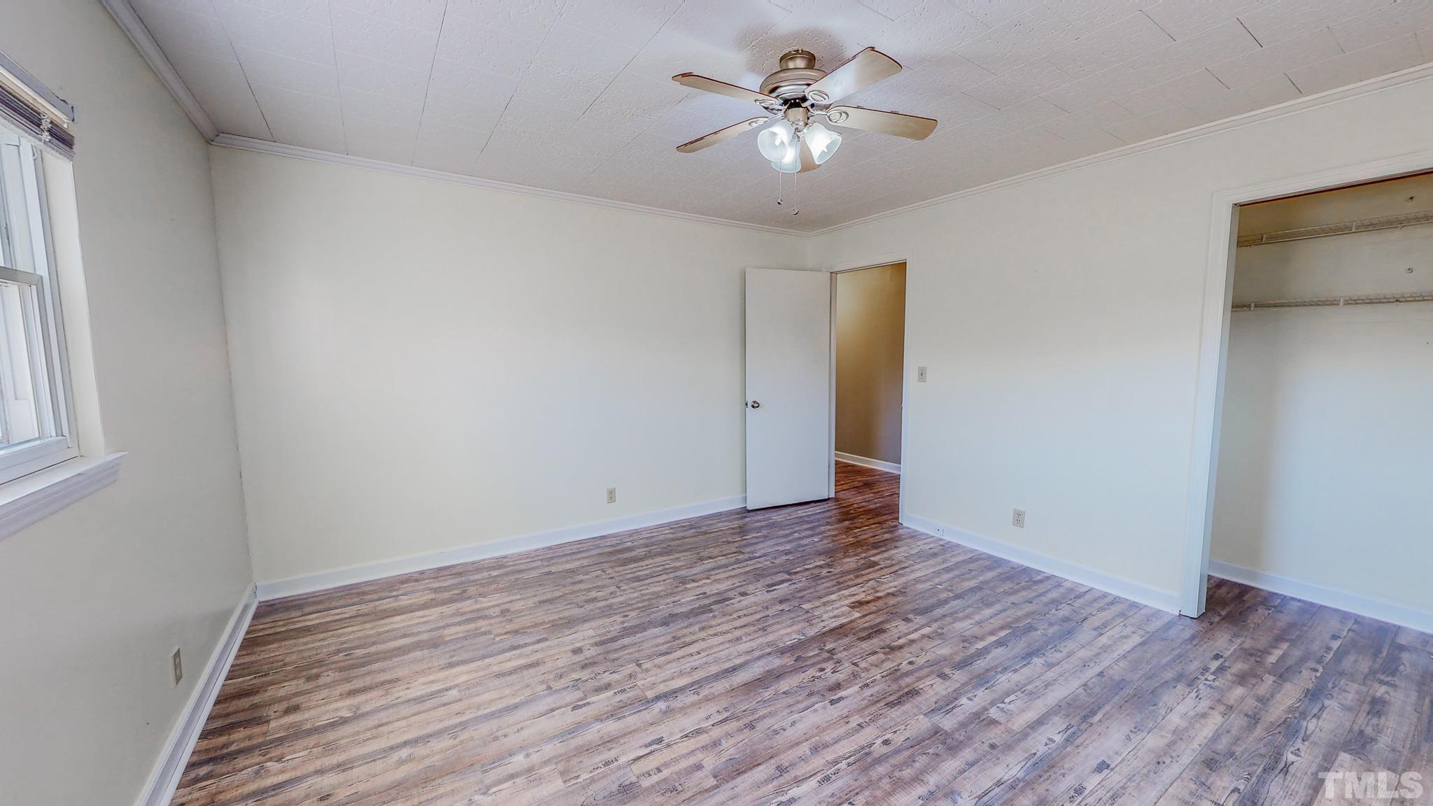3772 Mt Harmony Church Road Rougemont, NC 27572 - Photo 24 of 66 an empty room with wooden floor and ceiling fan