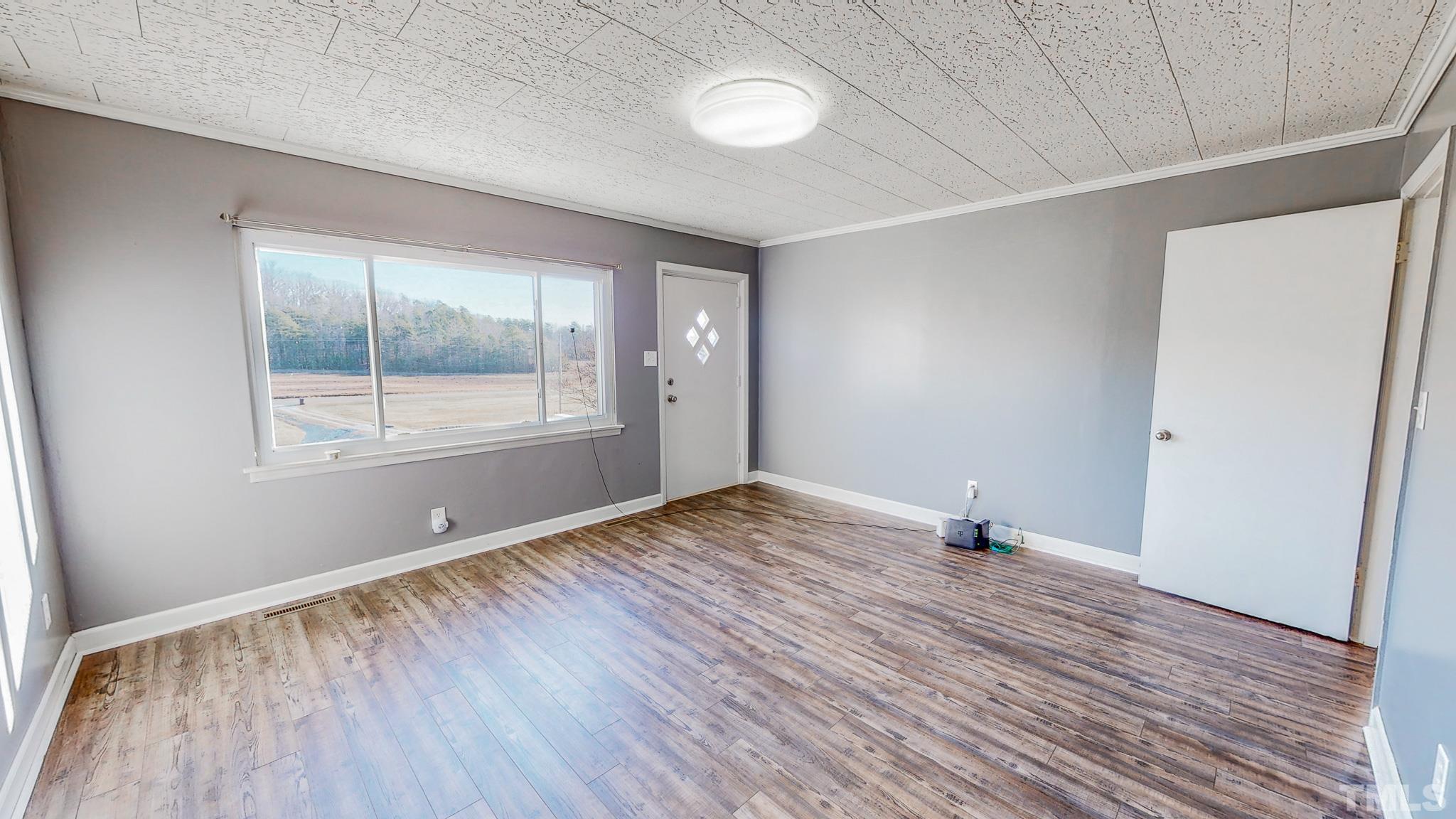 3772 Mt Harmony Church Road Rougemont, NC 27572 - Photo 3 of 66 an empty room with wooden floor and windows