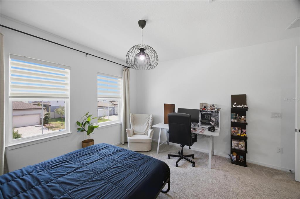13816 Sharp Hawk Drive Riverview, FL 33569 - Photo 56 of 76 a bedroom that has a bed and a chair in it