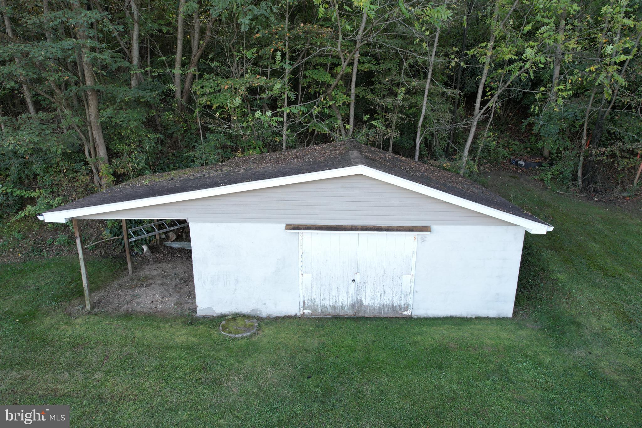 2255 Quarry Road Lebanon, PA 17046 - Photo 54 of 57 Charming shed nestled in lush greenery.