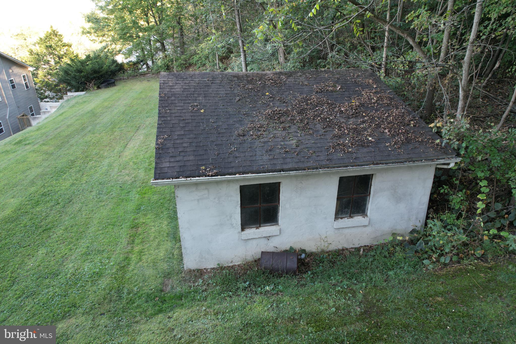 2255 Quarry Road Lebanon, PA 17046 - Photo 56 of 57 Charming rustic shed amidst lush greenery.