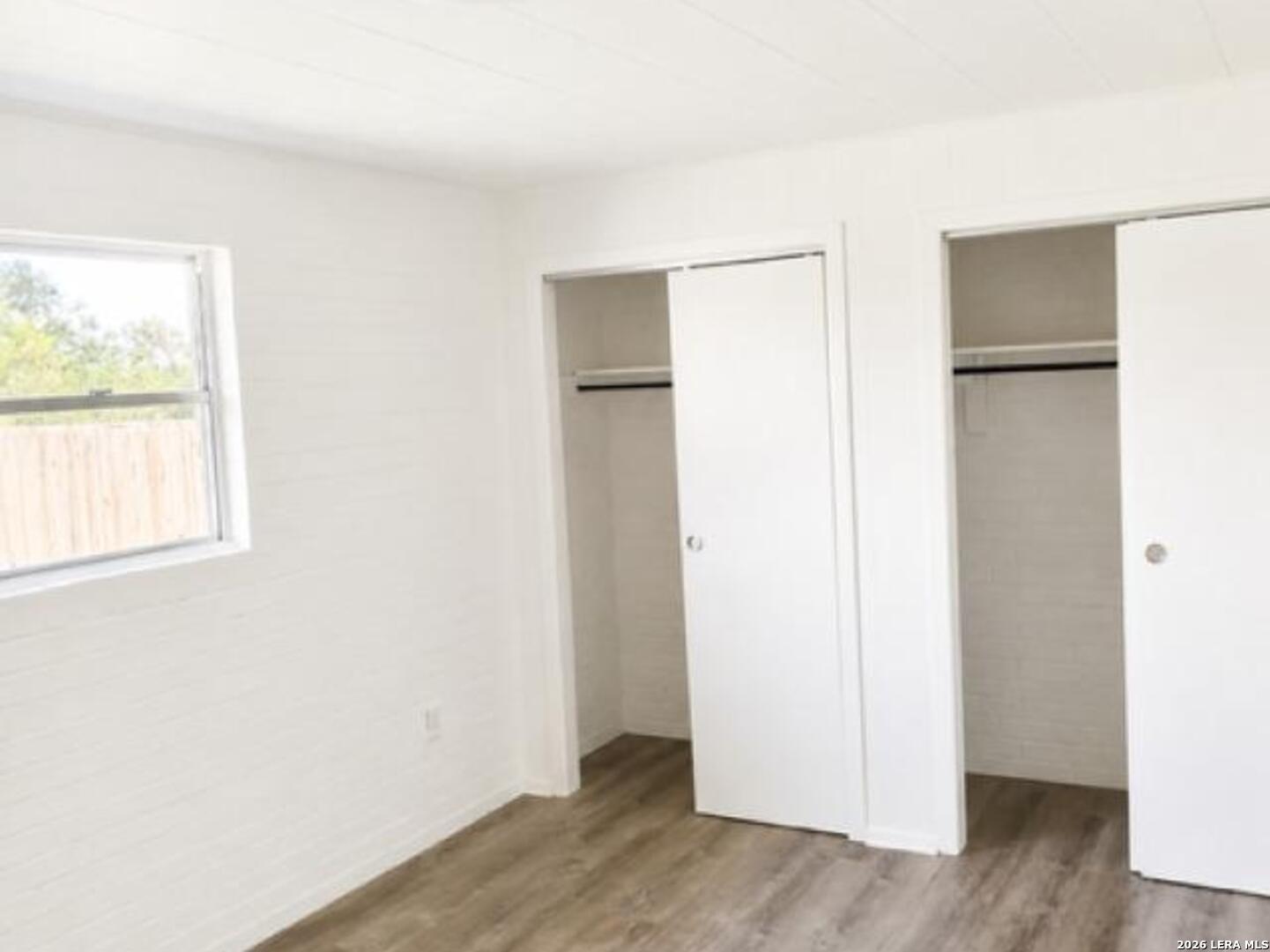 208 Forrest Road, Unit A La Vernia, TX 78121 - Photo 7 of 7 a view of an empty room with wooden floor and a window