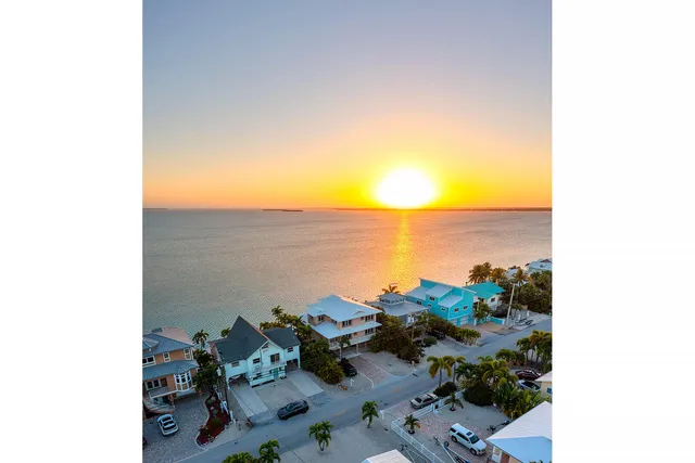 a living room with furniture a ceiling fan and a flat screen tv