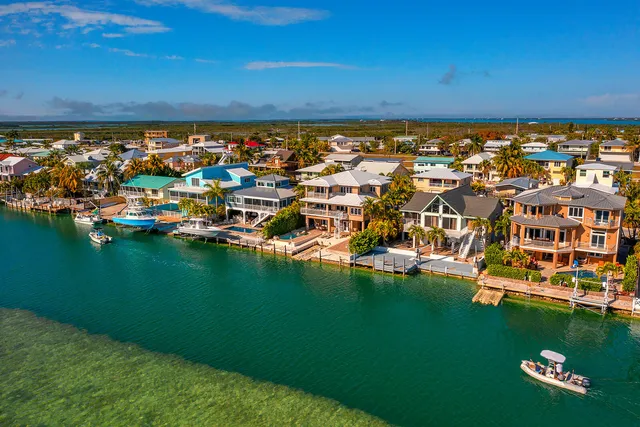a large kitchen with granite countertop a lot of counter space and wooden floor