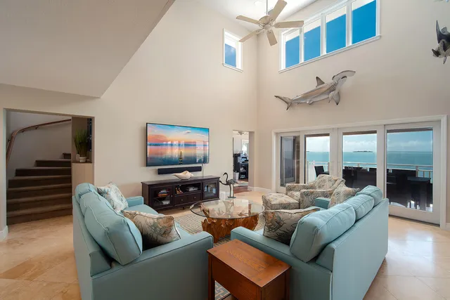 a living room with furniture and a ceiling fan