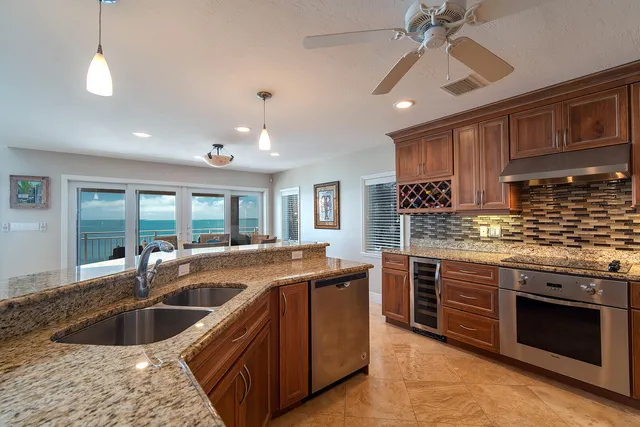 a large bed sitting in a bedroom next to a window