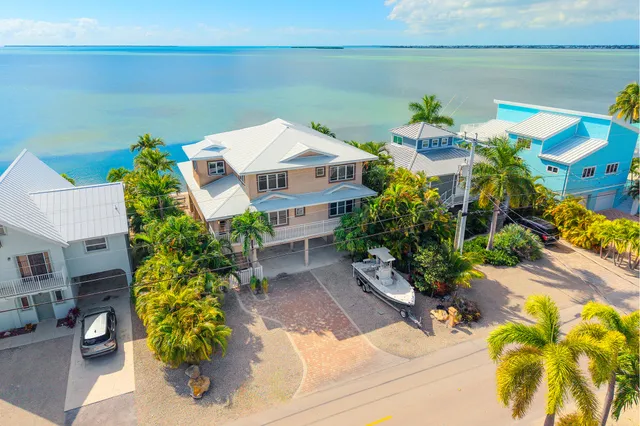 an aerial view of residential houses with outdoor space and street view